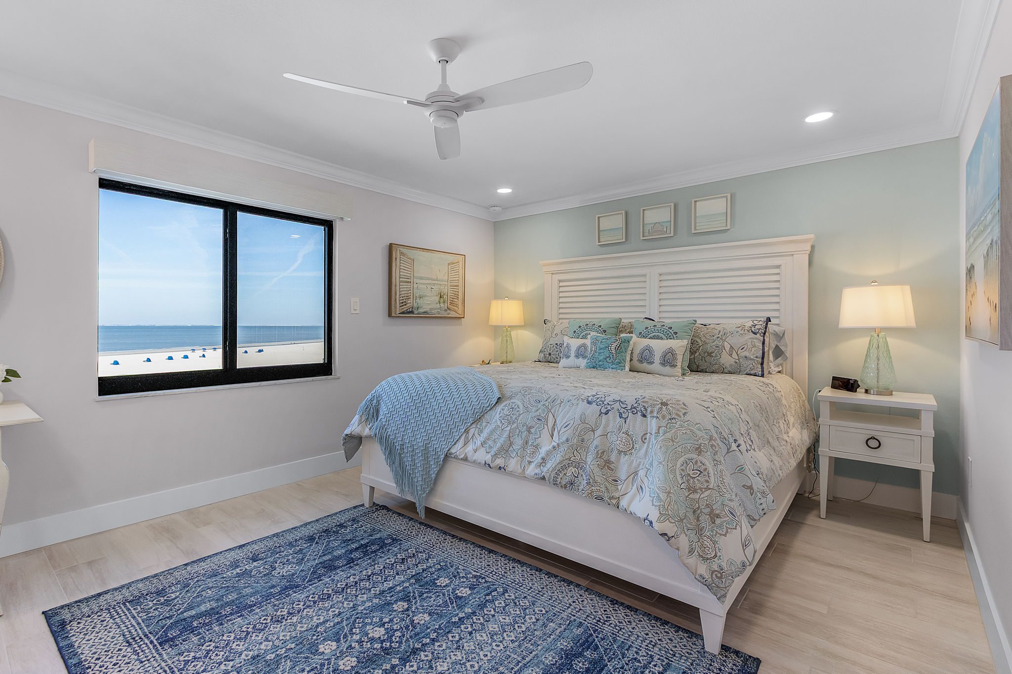 Bright, coastal-style bedroom in Southwest Florida beachfront condo designed for luxury living by the ocean