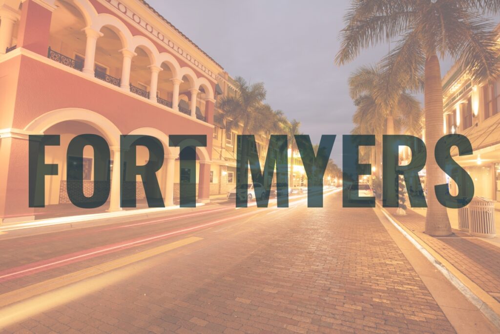 Historic Fort Myers district lit by evening streetlights—capturing the charm of coastal living and vibrant community atmosphere