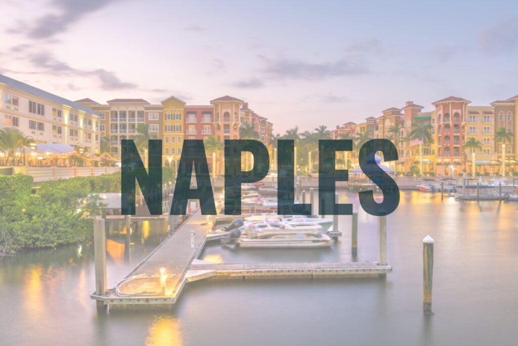 Naples waterfront with luxury buildings, boat docks, and calm Gulf waters—showcasing high-end Southwest Florida real estate and lifestyle