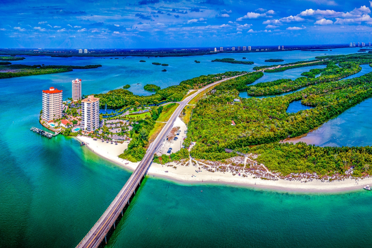 Aerial view of Lovers Key in Bonita Springs with lush greenery and water on both sides—highlighting Southwest Florida’s natural beauty and island living